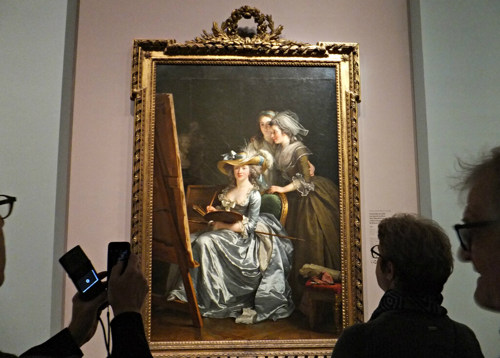 Visitors viewing classical painting